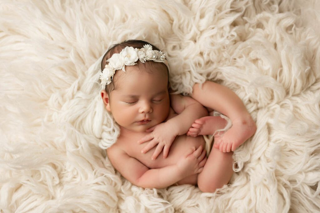 Peacefully Sleeping Newborn Photographed With Soft Studio Lighting During A Newborn Photography Session In Dallas.