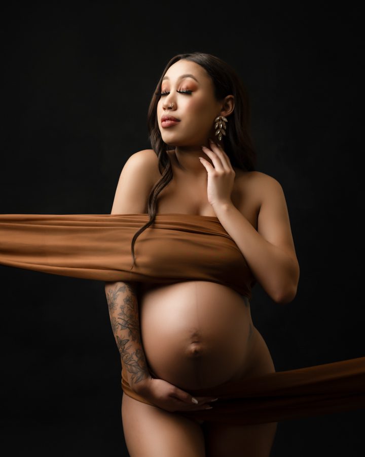 semi nude maternity photo with brown chiffon covering chest