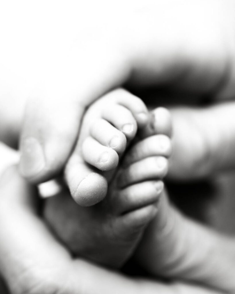 Black &Amp; White Newborn Photography In Dallas 15 Newborn Holding A Parent'S Finger During A Black And White Newborn Photography Session.