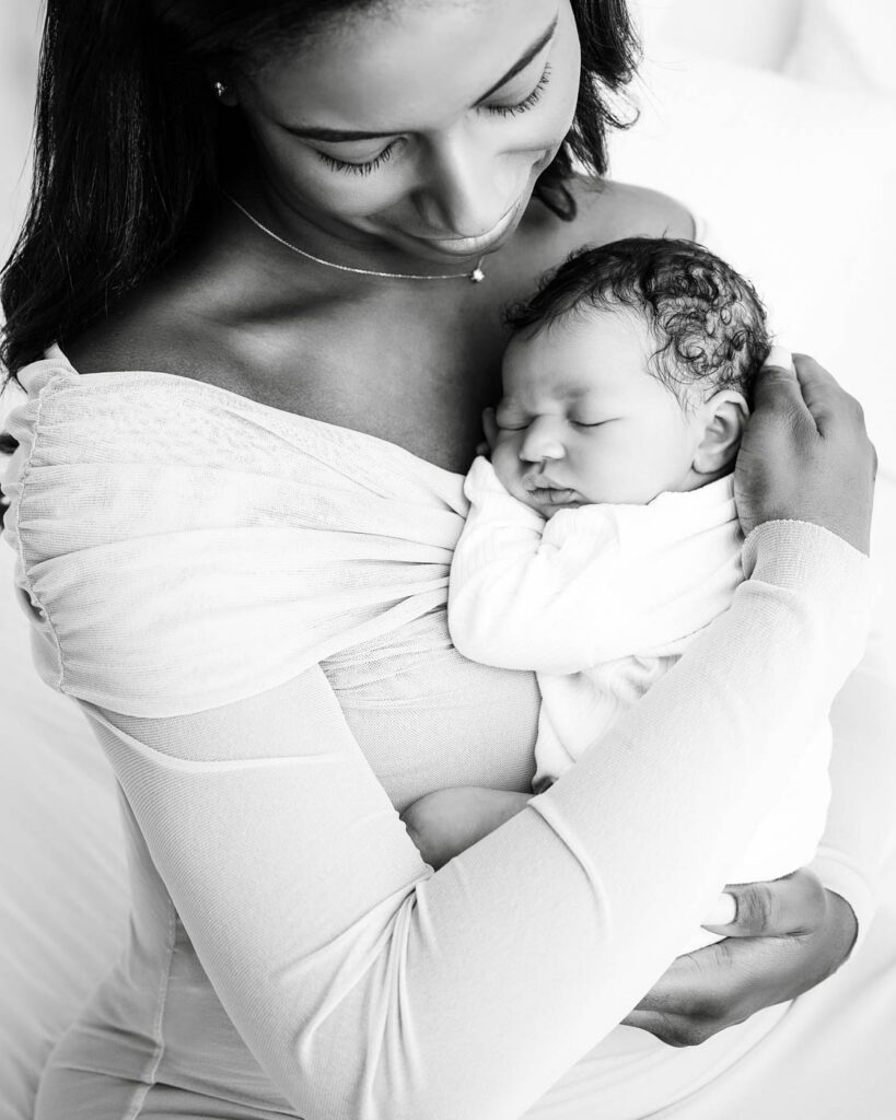 Black &Amp; White Newborn Photography In Dallas 18 Mother Holding Her Sleeping Newborn During A Luxury Newborn Photography Session In Dallas.