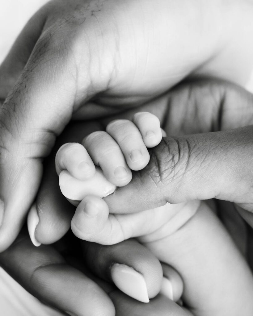 Black &Amp; White Newborn Photography In Dallas 16 Close-Up Photograph Of A Newborn'S Tiny Fingers Wrapped Around A Parent'S Thumb