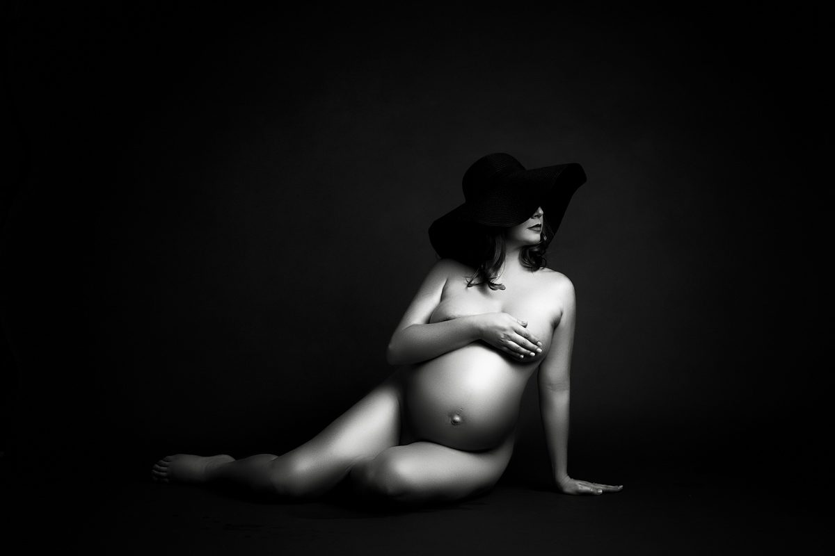 black and white pregnant photo woman wearing a hat