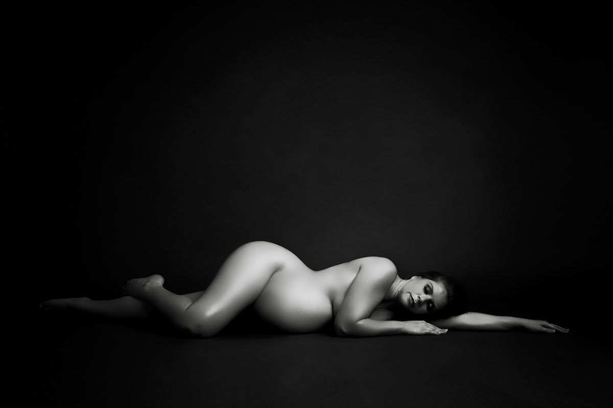 pregnancy nude maternity photo laying on her side
