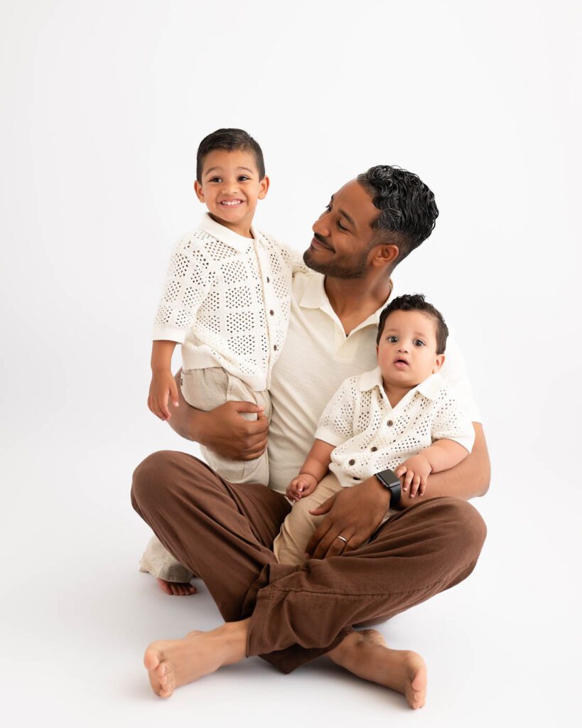 Why Include Siblings In Your Cake Smash Session? 18 Father Holding Both Sons During A Family Cake Smash Photography Session In Dallas.