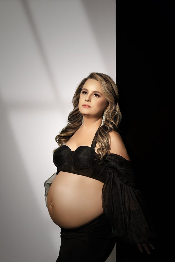 fashion maternity photoshoot woman holding belly