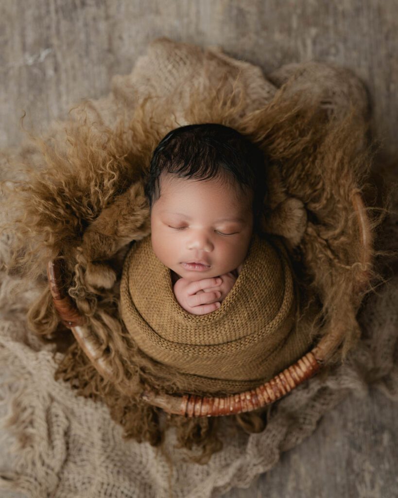 Sleeping Newborn Wrapped In Warm Neutral Layers During A Timeless Fine Art Newborn Photography Session.