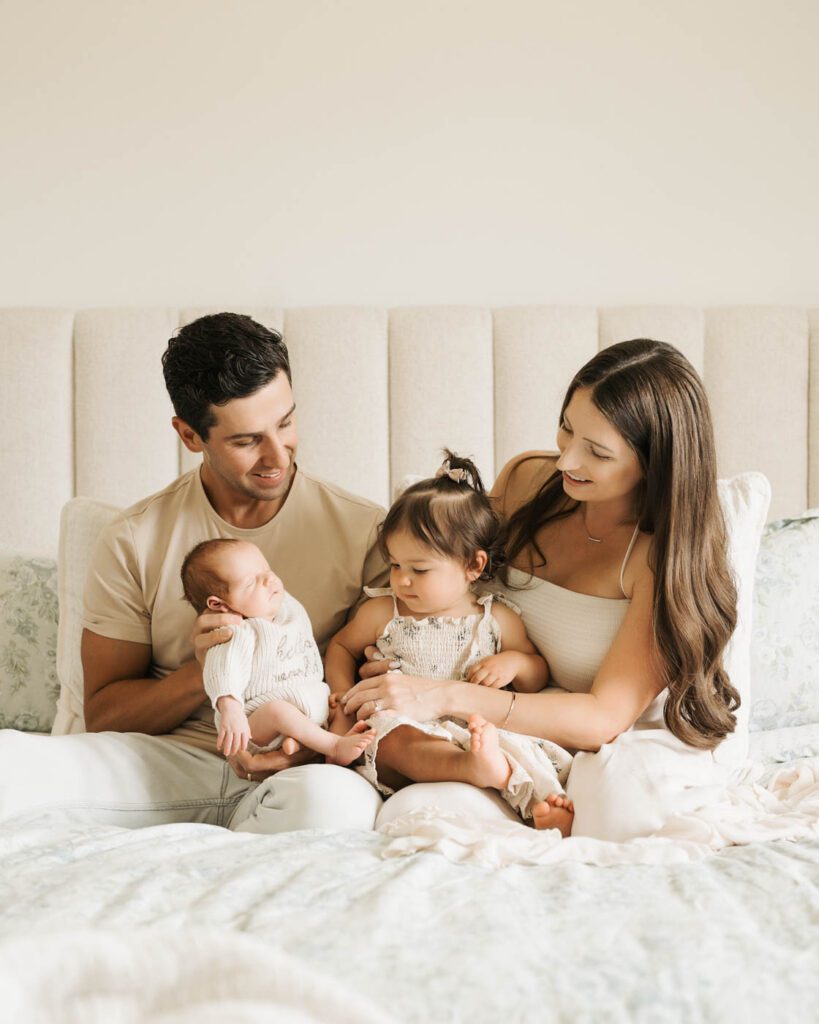 Postpartum Newborn Photography: Supporting New Parents Through A Calm, Thoughtful Experience 17 Family Gathered Together On A Bed During A Relaxed Lifestyle Newborn Photography Session In Dallas.