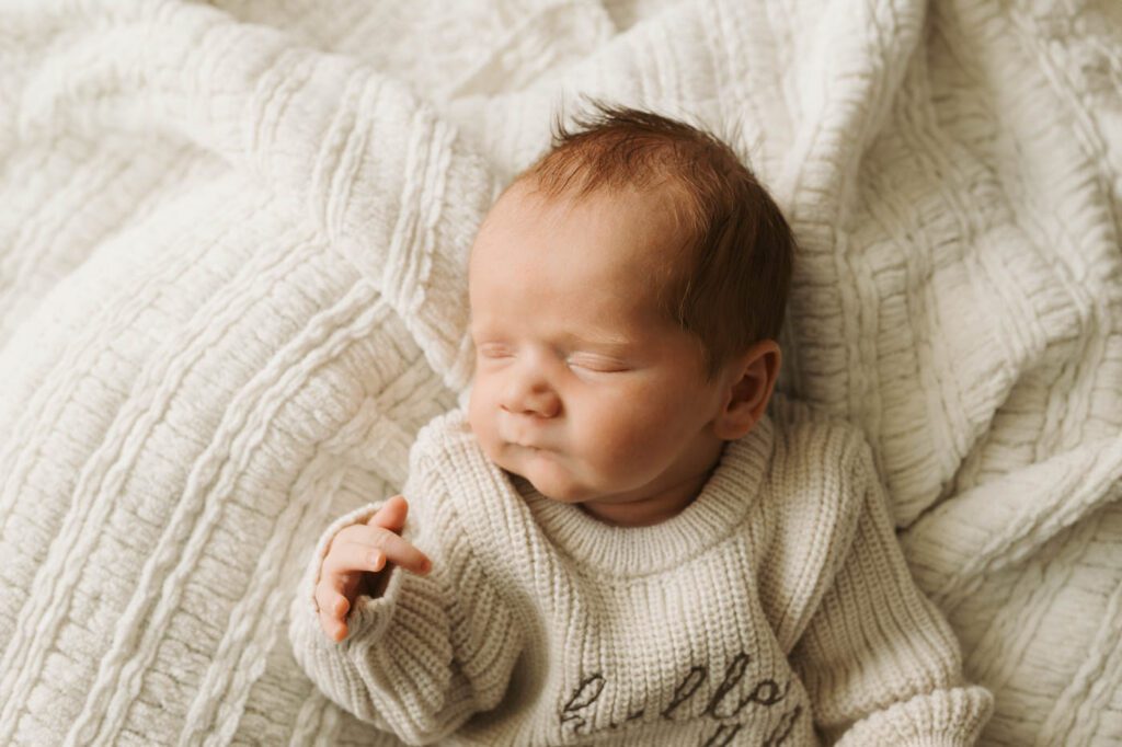 Postpartum Newborn Photography: Supporting New Parents Through A Calm, Thoughtful Experience 14 Peacefully Sleeping Newborn Photographed In A Soft Neutral Setup At A Dallas Newborn Photography Studio.