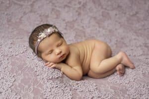 Newborn Baby Peacefully Sleeps On A Lace-Covered Surface Perfect For Photography For Infants