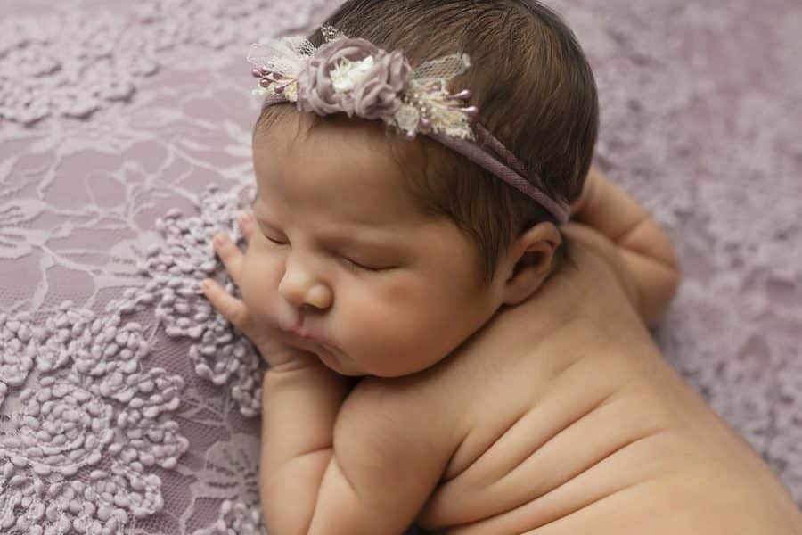 Newborn Rests On A Textured Lavender Blanket, Perfectly Capturing Editing Styles In Dallas Newborn Photography.