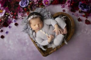 Newborn Posed In Wooden Heart-Shaped Bowl Perfect For Exploring Editing Styles In Dallas Newborn Photography