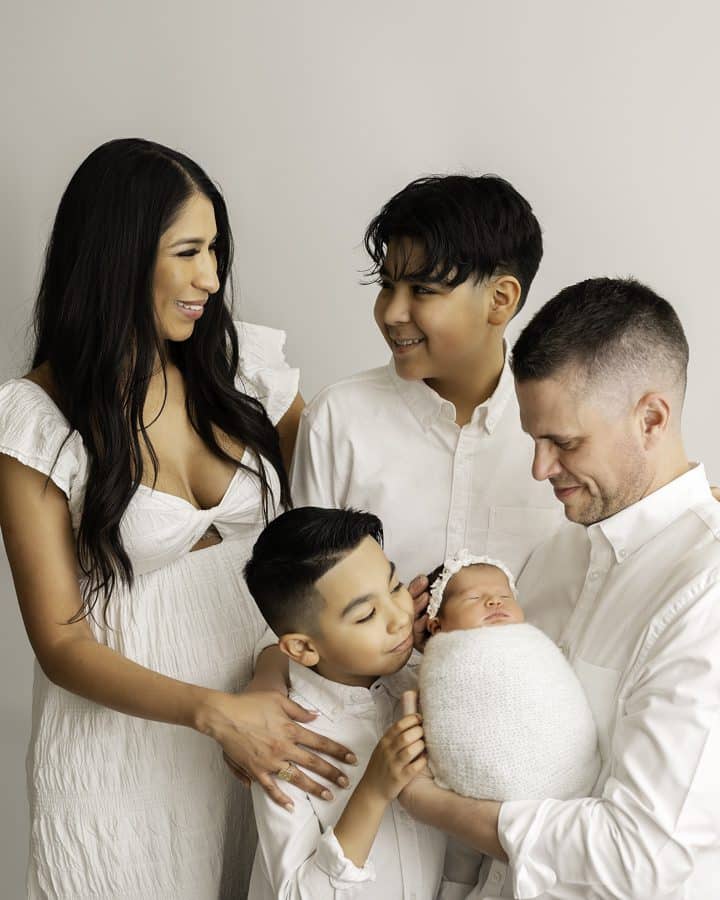 Family Happily Smiling Looking At Each Other During A Newborn Photoshoot With Newborn Photographer | Lily Hayes Photography