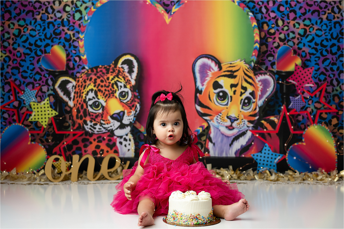 Baby Eating Cake In Front Of A Lisa Frank Dallas Cake Smash Photography Session 