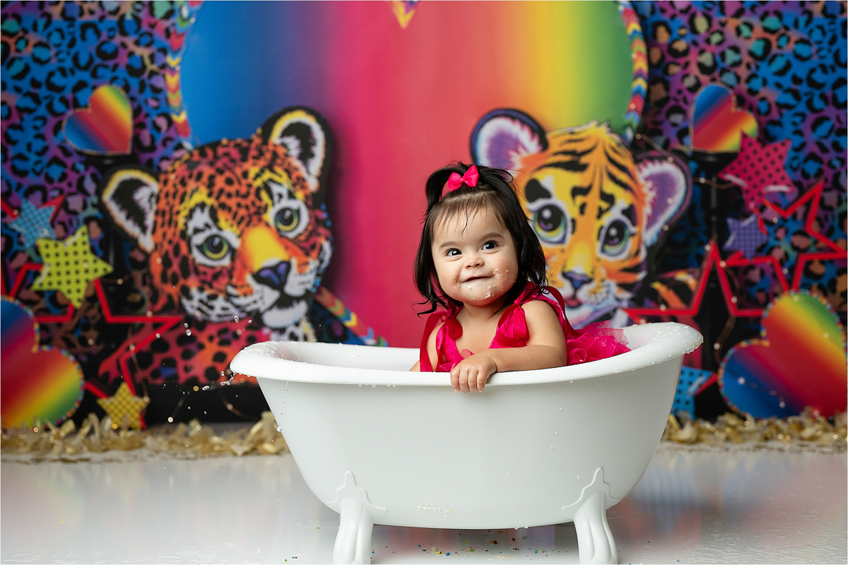 Baby Sitting In A Small Bathtub Splashing Water For A Smash Cake Photoshoot Dallas