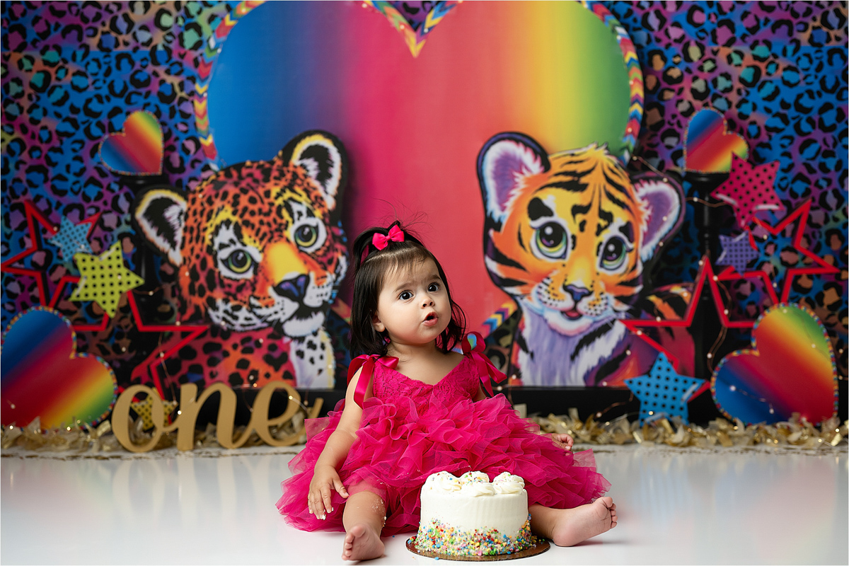 Child Eating Cake During A Lisa Frank Cake Smash Themed Session With Plano Cake Smash Photographer