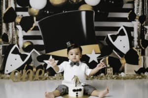 Baby Smiling At Camera In A New Years Eve Party Themed Cake Smash Photoshoot | Pricing For Dallas Cake Smash Photography