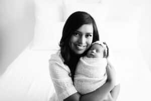 Mother-Smiles-While-Holding-Newborn-Baby-For-Affordable-Newborn-Photographer-Lily-Hayes-Photography