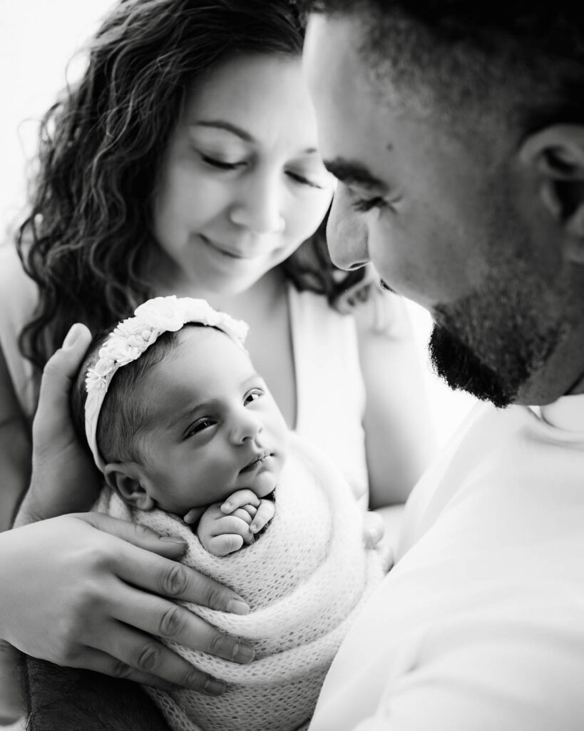 Best Lens For Newborn Photography In Dallas 11 Parents Holding Their Newborn Baby During A Dallas Newborn Photography Session