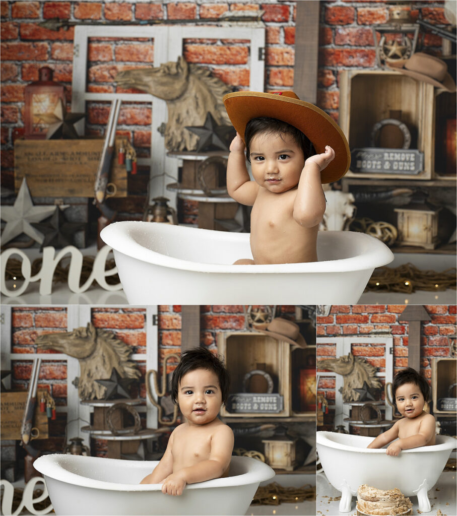 A Baby Sits In A White Bathtub Wearing A Brown Cowboy Hat, Ready For Their Cowboy Cake Smash Photoshoot. The Backdrop Boasts A Rustic Style With Red Brick, Wooden Decor, And The Word &Quot;One,&Quot; Making It A Perfect Memory To Capture In Dfw.