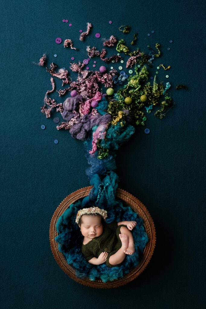 newborn posed in wooden bowl for newborn photographer dallas