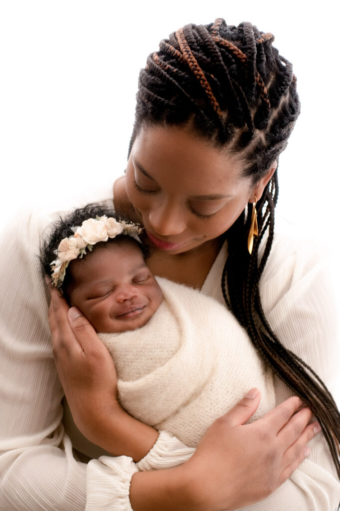 Mother Holding Her Newborn Baby During A Lifestyle Newborn Photography Session In Dallas Texas