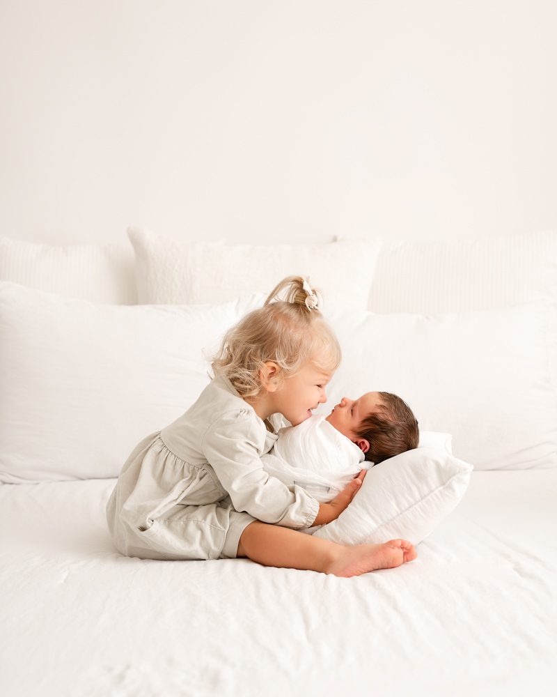Big Sister Smiling At Baby Brother For Dallas Newborn Photographer