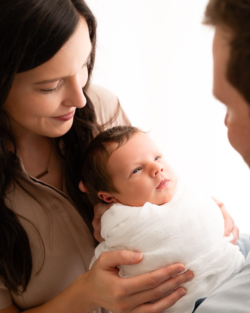 Close Of Photo Of Newborn Smiling At Dad For Dfw Newborn Photographer