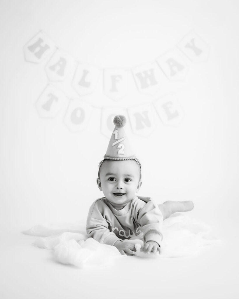 Baby Boy Smiling During A Diy Birthday Cake Smash Photoshoot With Neutral Styling