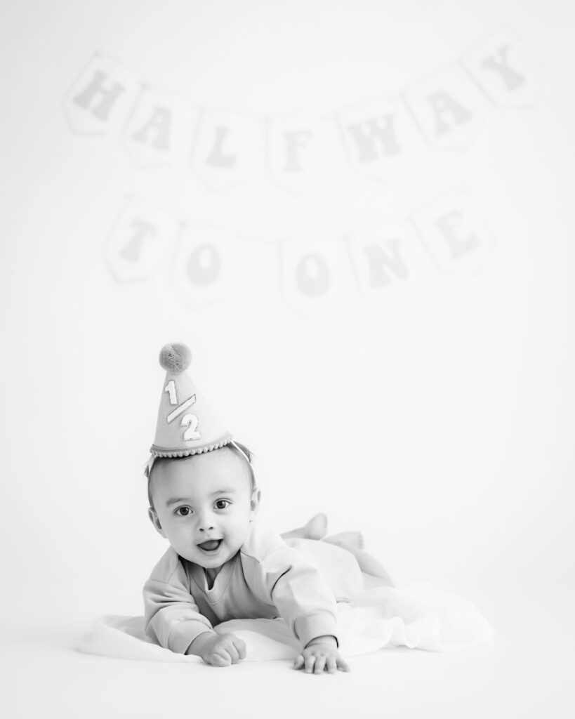 Minimal Neutral Diy Birthday Photoshoot Setup With Baby Sitting On A Soft Backdrop