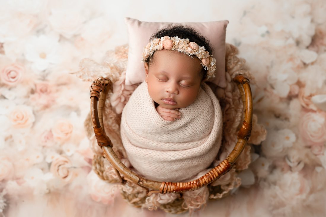 Newborn Sleeps Peacefully Wrapped In A Woven Basket For Dfw Newborn Photographer