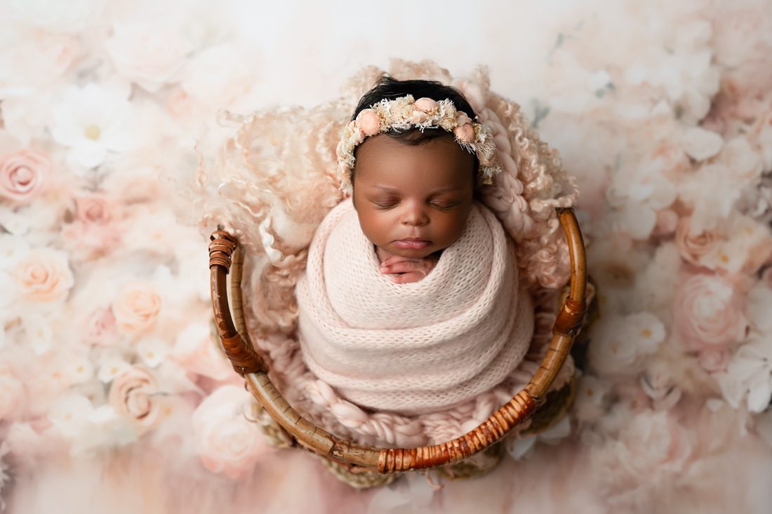 Newborn Baby Peacefully Sleeping In A Basket For Dfw Newborn Photographer