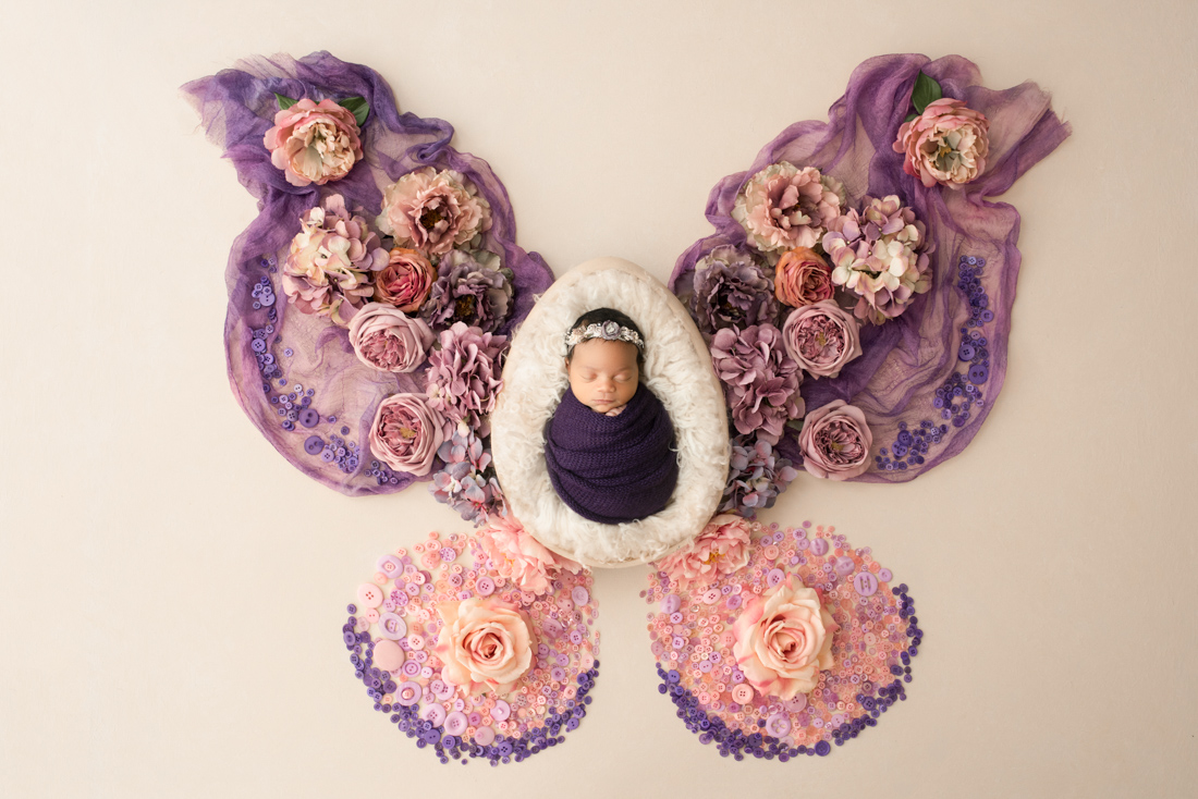 baby wrapped surrounded by floral arranged for dfw baby photographer