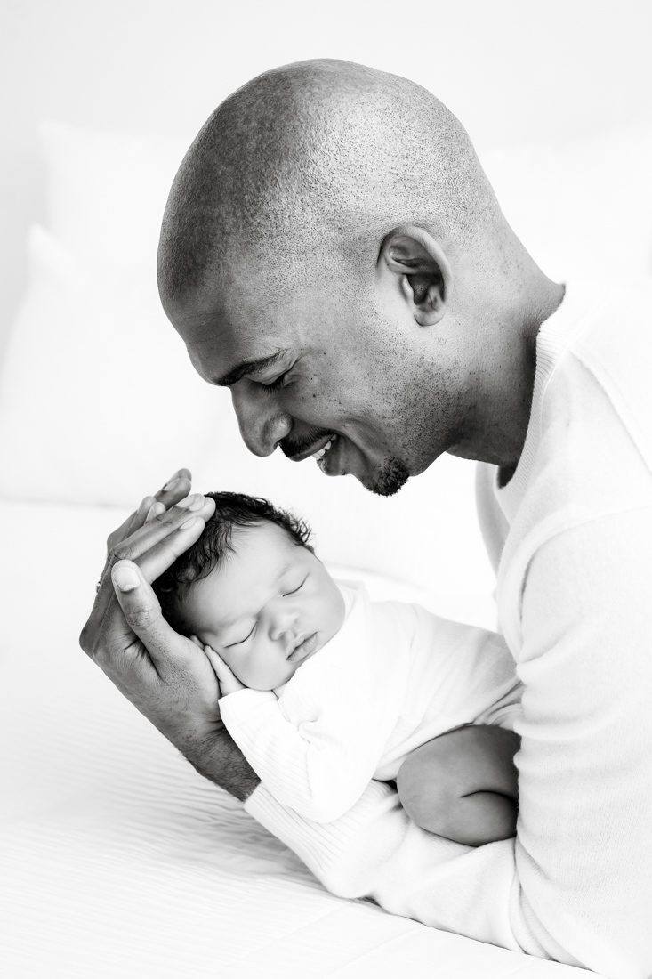 Dallas Lifestyle Photographer Captures A Tender Moment With Father Holding Newborn Son