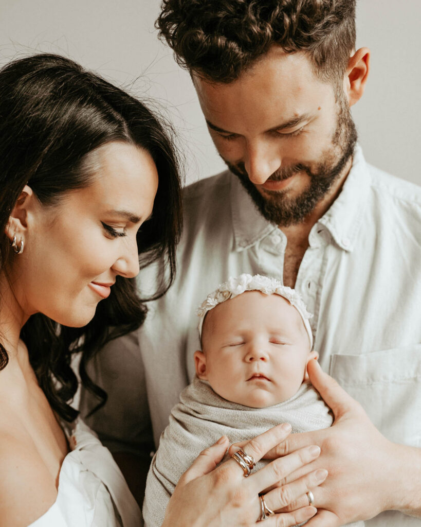 Parents Holding Newborn During Lifestyle Newborn Photography Session In Dallas