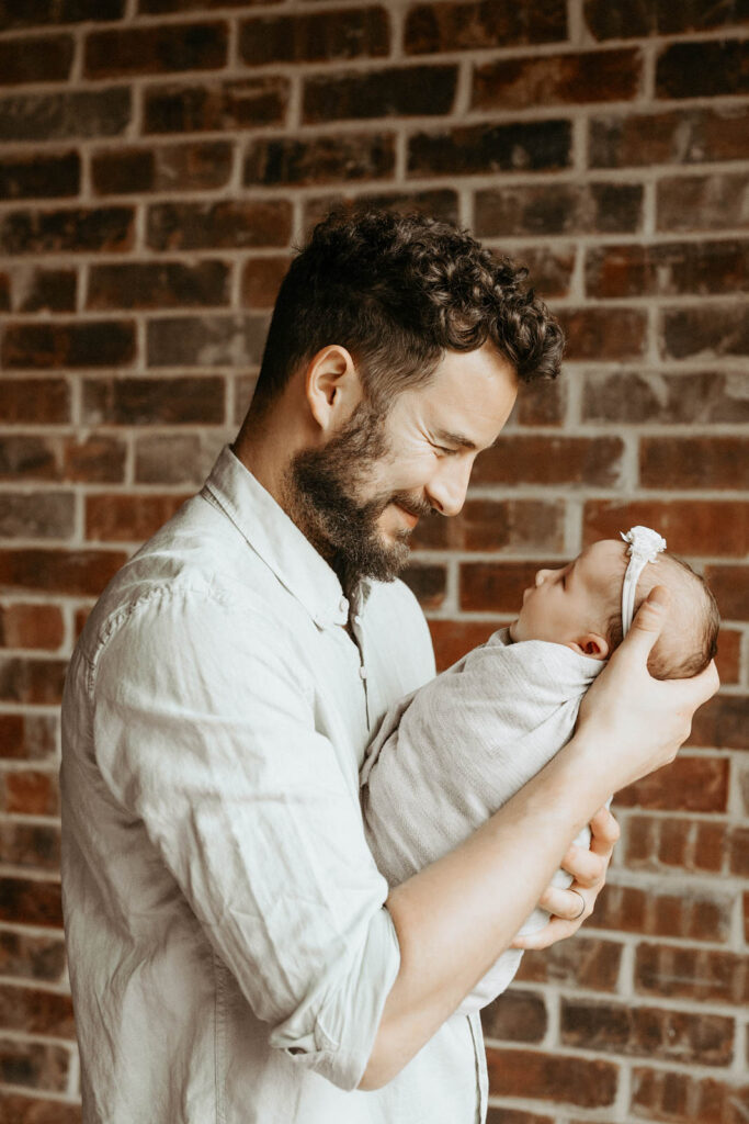 Father Holding Newborn During In-Home Lifestyle Newborn Photography Session