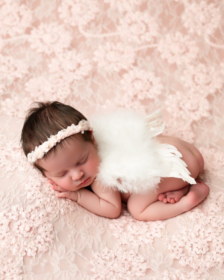 baby sleeping on a soft pink lace blanket for dfw newborn photographer