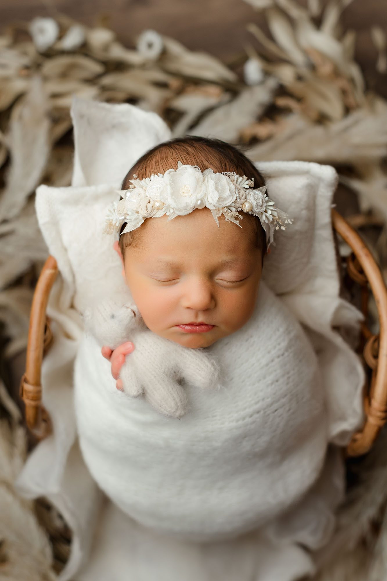 Sleeping Newborn Holding A Tiny Teddy Bear During Professional Dallas Newborn Photography Session