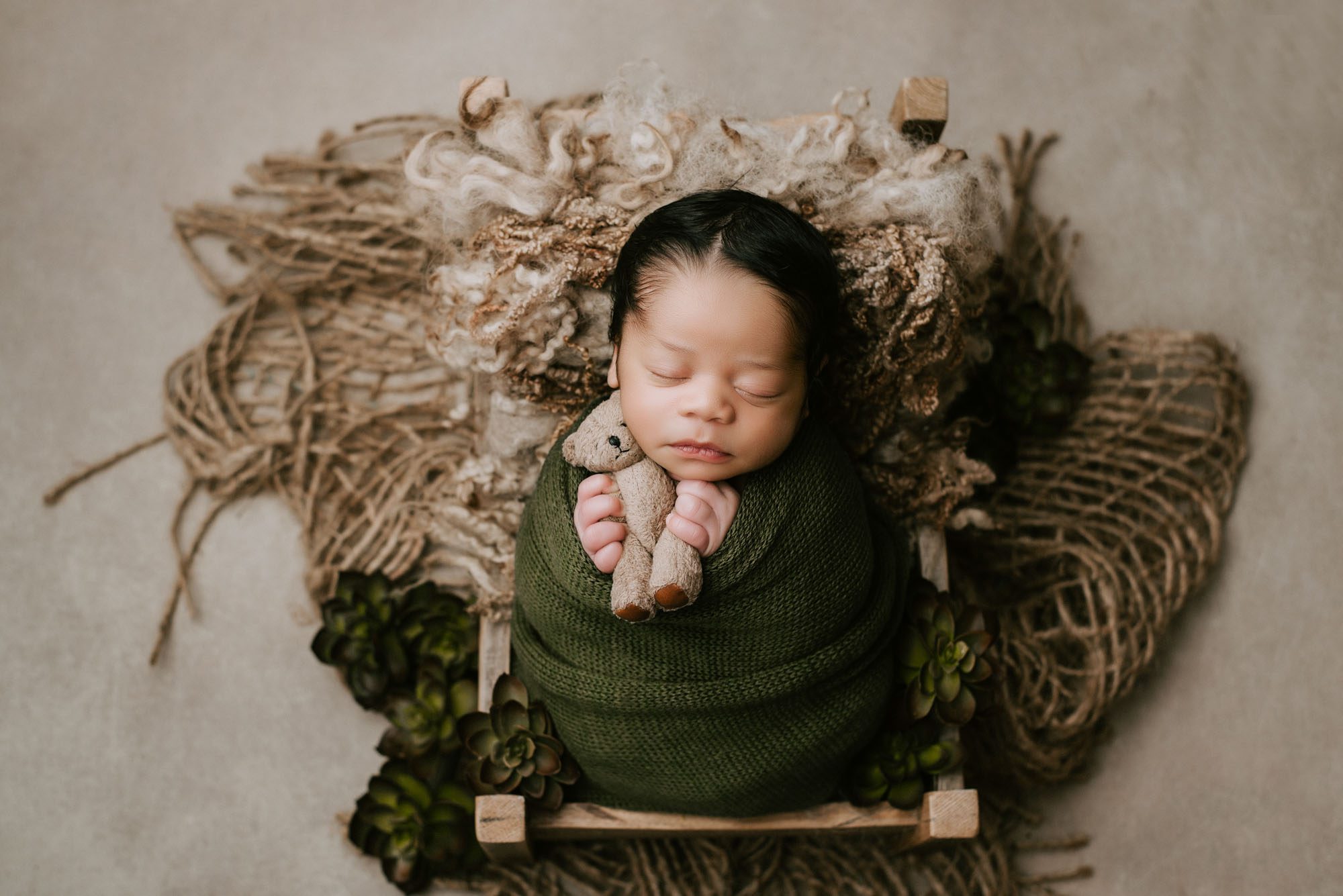 Newborn Baby Boy Sleeping In Green Wrap Holding Teddy Bear – Dallas Newborn Photographer