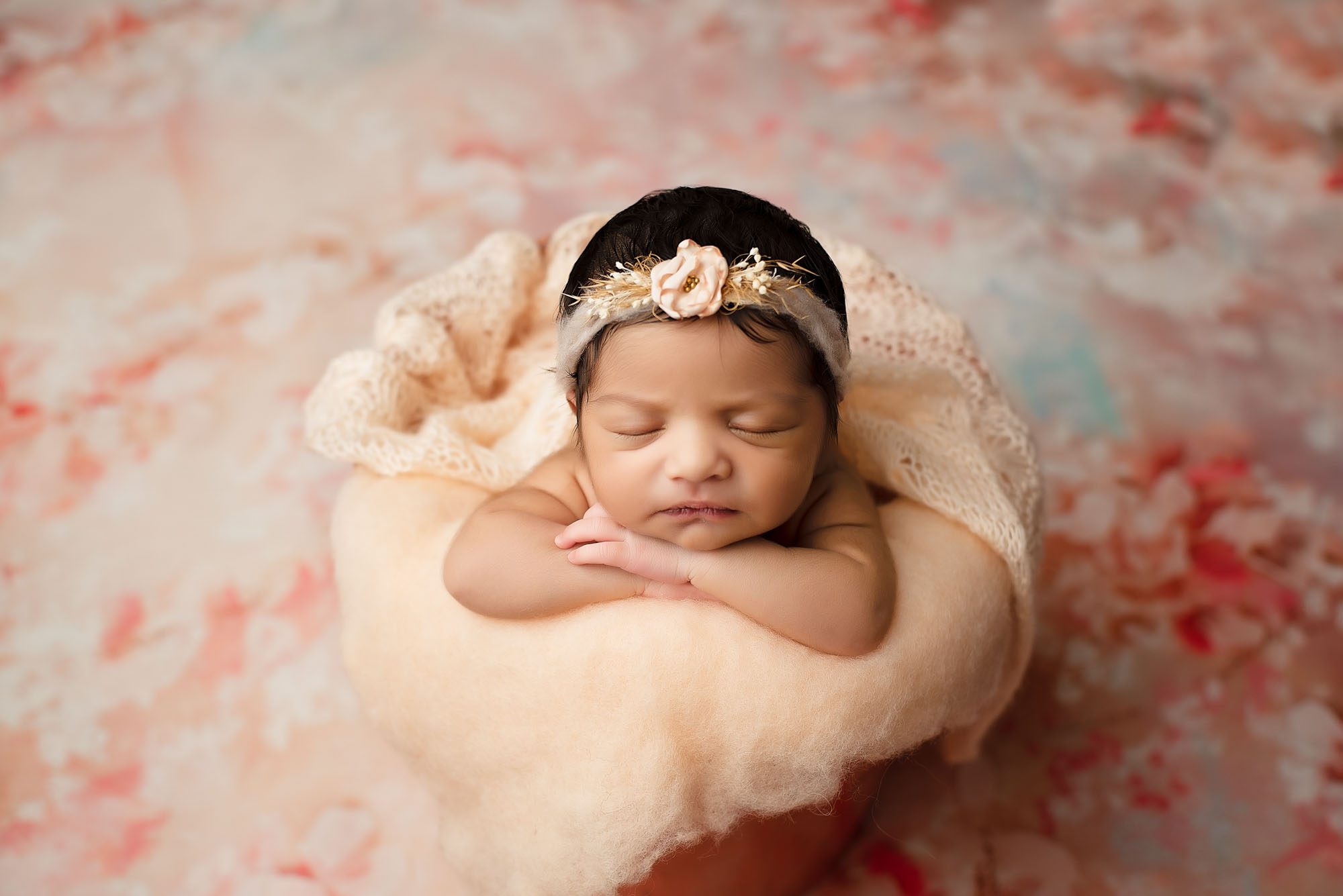 Newborn Baby Girl Posed In Peach Bucket With Floral Headband By Dallas Baby Photographer
