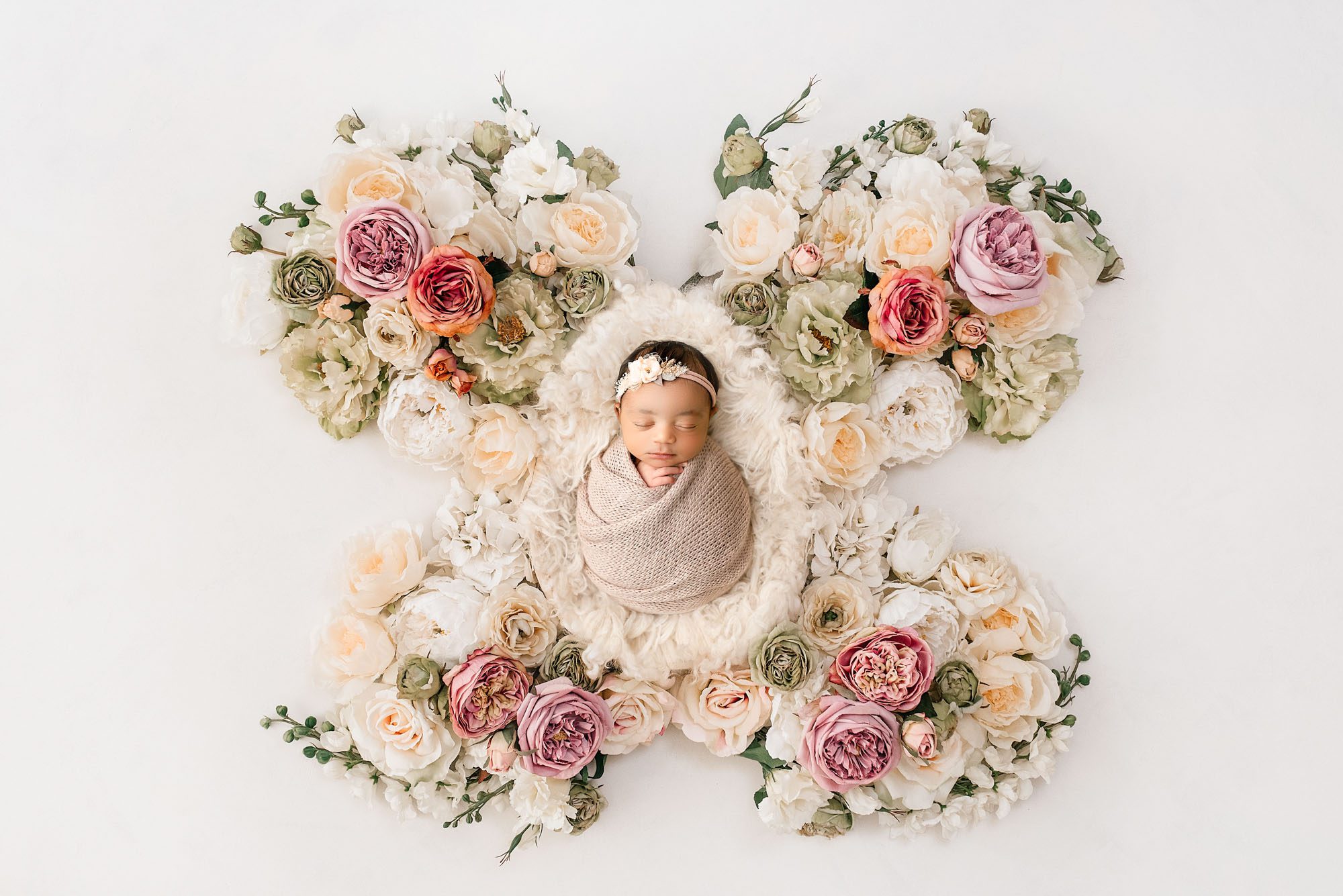 Professional Dallas Newborn Photographer | Why It'S Worth The Investment 1 Professional Newborn Photographer Captures Baby Girl Wrapped In Beige Surrounded By Pastel Floral