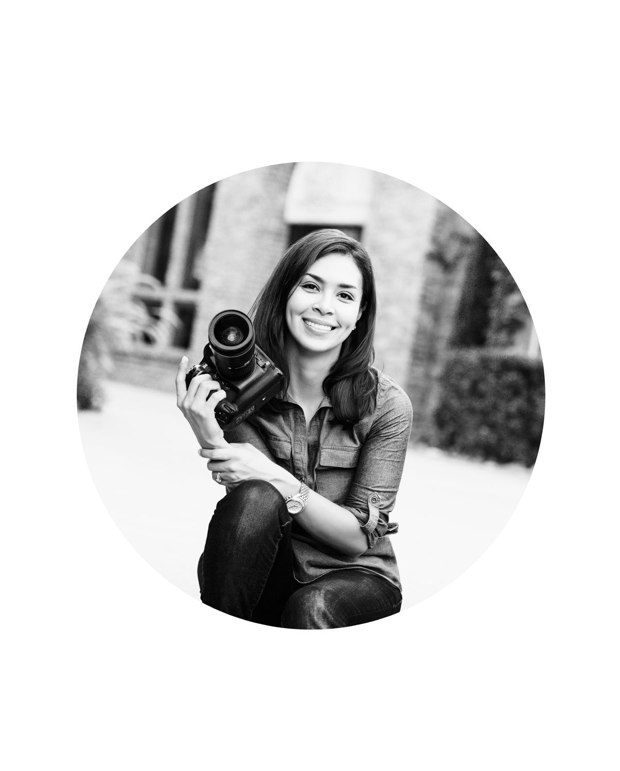 Dallas newborn baby photographer Lily Hayes holding camera, professional portrait for luxury newborn and cake smash photography studio