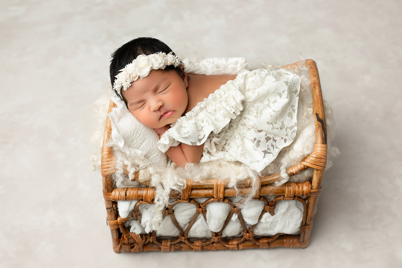 Sleeping Newborn Baby Posed In Woven Basket With Soft Textures During Dallas Studio Session