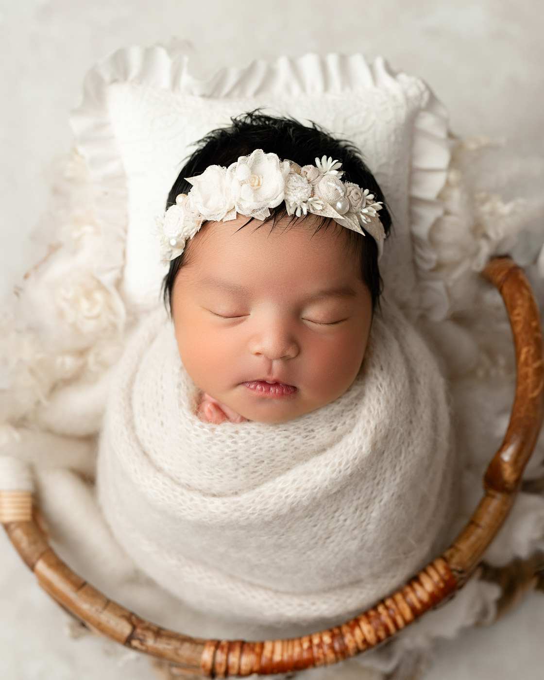Dfw Newborn Photography Baby Wrapped In Neutral Tones With Floral Headband Studio Portrait