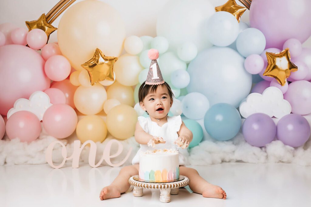Dallas Baby Photoshoot Outfit Ideas | Cake Smash &Amp; Milestone Guide 10 Baby Girl Celebrating Her First Birthday With A Rainbow Balloon Cake Smash Session In Dallas