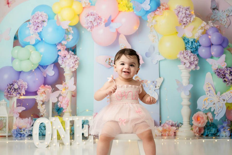 Butterfly Cake Smash Photography Session With Pastel Balloon Backdrop In Dallas