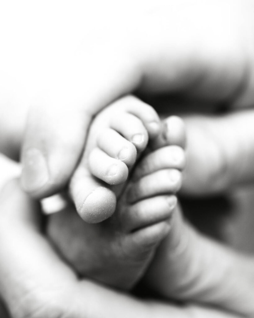 Newborn Baby Hand Holding A Parent'S Finger During A Dallas Newborn Photography Session