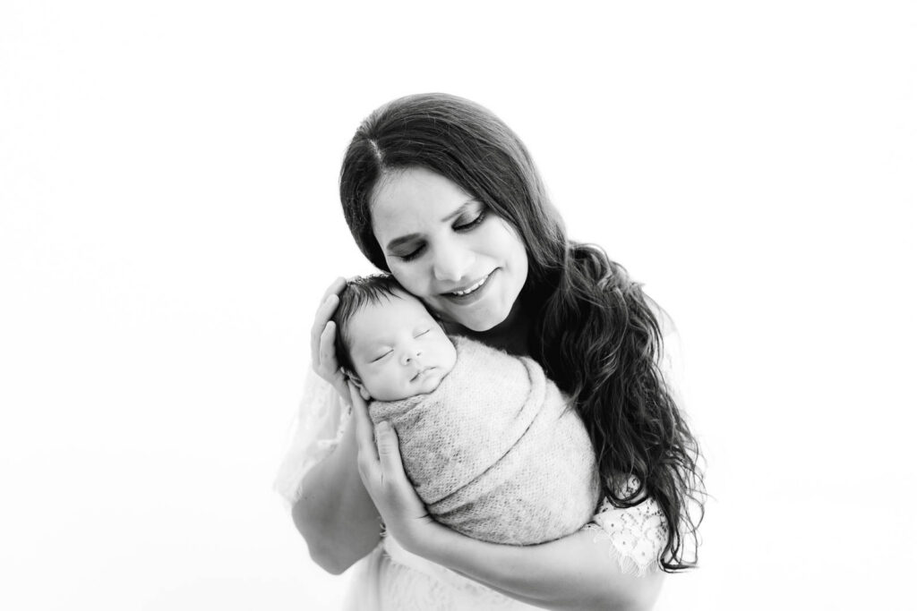 Mother Holding Her Newborn Baby During A Dallas Newborn Photography Session