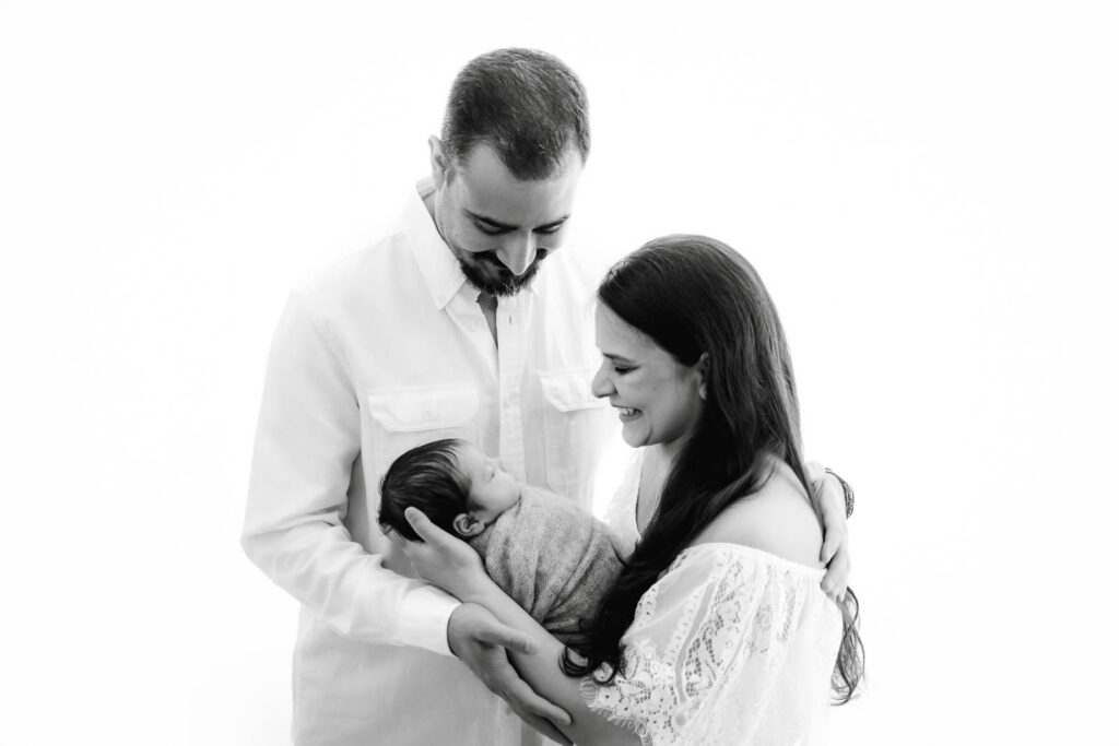 Parents Holding Their Newborn Baby During A Dallas Newborn Photography Session