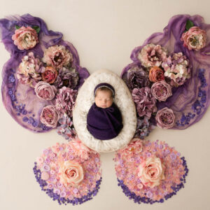 Fine art newborn portrait by Dallas newborn photographer Lily Hayes featuring a sleeping baby surrounded by handcrafted floral details.