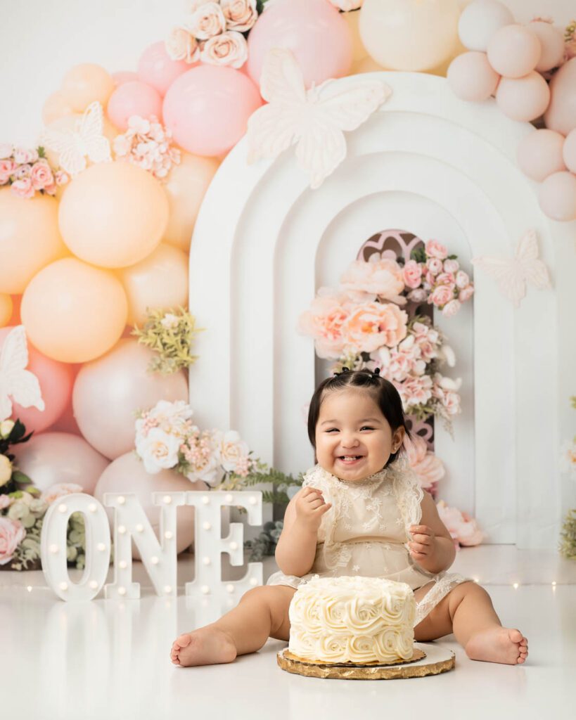 Smiling Baby Girl During Cake Smash Birthday Photography Session In Dallas